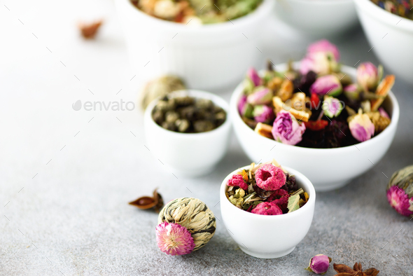 Assortment of dry tea in white bowls. Tea types backgound: green, black, floral, herbal, mint