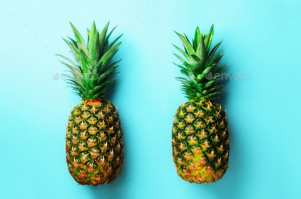 Fresh pineapples on blue background. Top View. Pop art design, creative concept. Copy Space. Bright - Stock Photo - Images