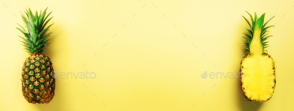 Half slice of fresh pineapple and whole fruit on yellow background. Banner. Top View. Copy Space - Stock Photo - Images