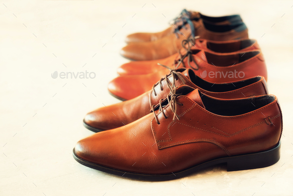 Classic fashion polished men's brown shoes on gray background. Selective focus. Copy space - Stock Photo - Images