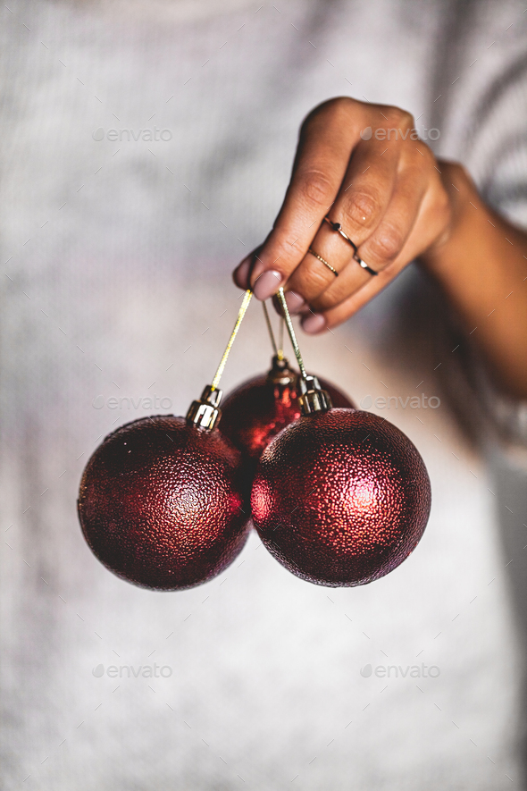 Woman in warm sweater holding toy glass decorative ball in hands, copy space. Christmas, new year - Stock Photo - Images