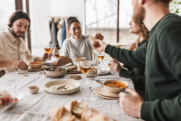Group of young international colleague spending time together on lunch in cafe - Stock Photo - Images