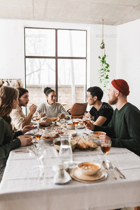 Young colleagues having lunch happily spending time in cozy cafe - Stock Photo - Images