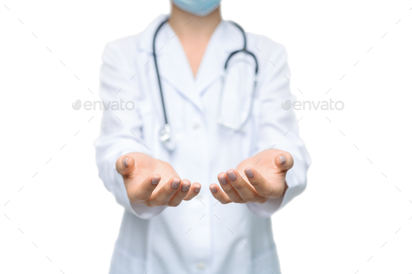 Unrecognizable female doctor holding some invisible items with both hands - Stock Photo - Images