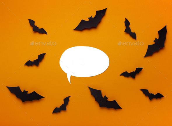 Halloween background with flying bats around empty speech bubble