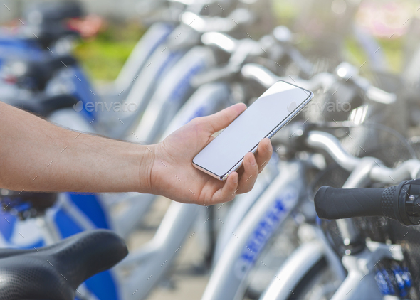 Man using mobile app at bikes sharing service, mockup - Stock Photo - Images