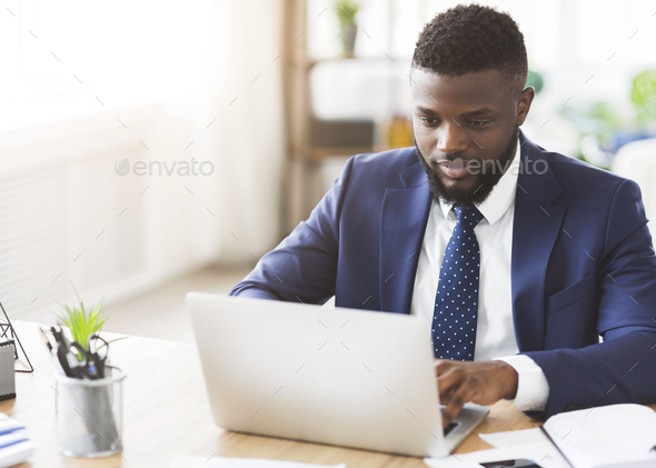 Young businessman working in modern high tech office