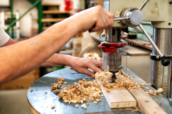 Woodworker or carpenter using a vertical drill - Stock Photo - Images