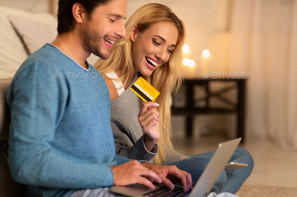 Man And Woman Shopping Holding Laptop And Credit Card Indoor