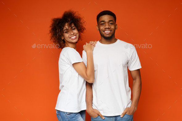 Young millennial black man and woman smiling together