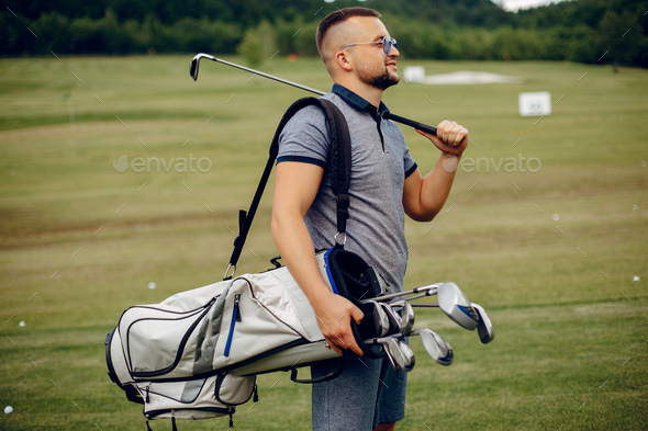 Handsome man playing golf on a golf course