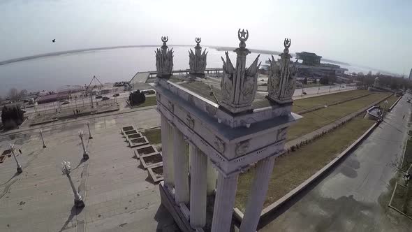 Flying over the aged columns on city waterfront Volgograd, Russia alt