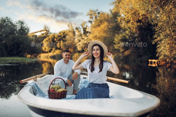 Love couple with fruit basket in boat
