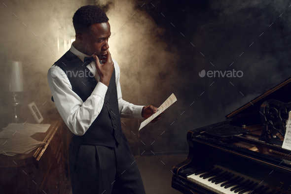 Black pianist with music notebook on the scene
