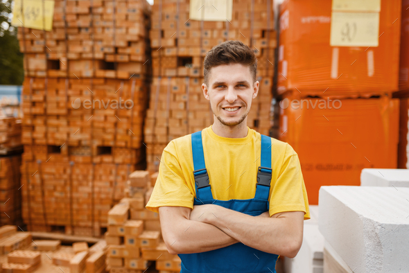 Builder at the pallets of bricks in hardware store
