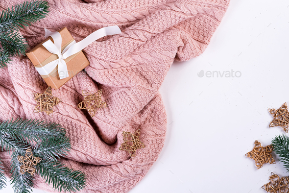 Pink knitted sweater with gift box, christmas decoration and fir branches on a white background, top - Stock Photo - Images