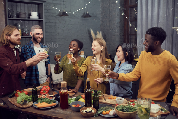 Multi-Ethnic Group of People Toasting at Dinner Party