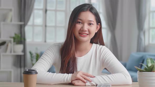 Asian Girl Waving Hand And Video Call At Home alt