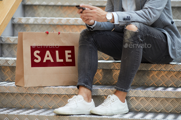 Man using Mobile App while Shopping - Stock Photo - Images