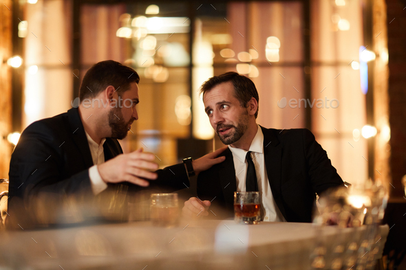 Two Business People Drinking in Restaurant