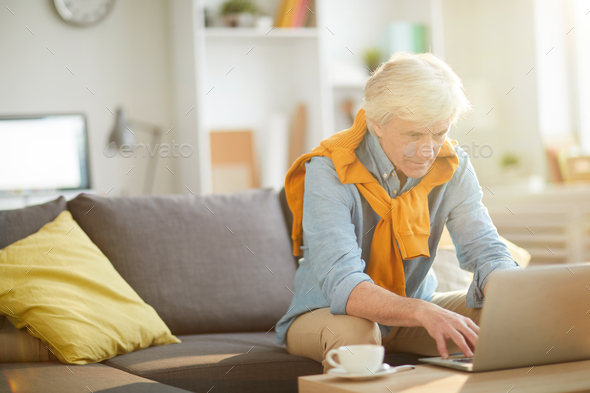 Modern Senior Man Using Laptop at Home