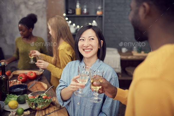 Asian Woman Enjoying Dinner Party