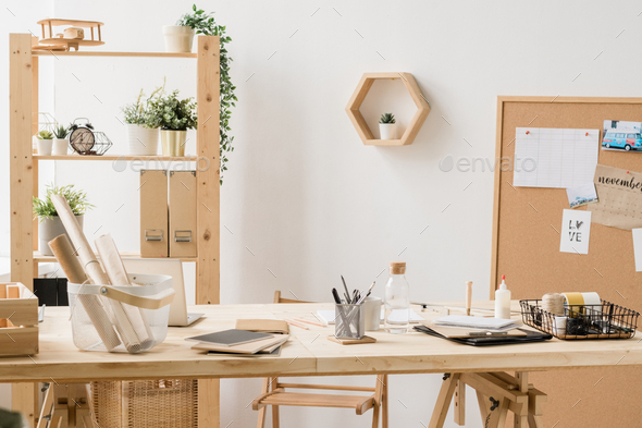 Rolled papers, copybooks, bottle of water and other stuff on wooden table - Stock Photo - Images