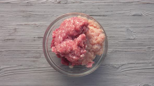 Top View of the Male Hands Mixing Various Kinds of the Raw Minced Meat alt