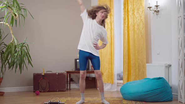 Wide Shot Portrait of Skinny Young Retro Man Exercising Indoors in 1980s or 1990s alt