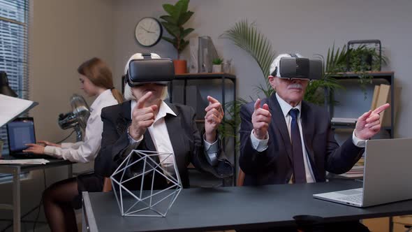 Senior Business Colleagues Using Virtual Reality 3D App Headset Helmet Doing Research Watching Video alt