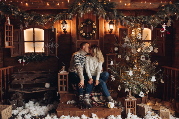 Christmas portrait of a romantic couple. beautiful house - Stock Photo - Images