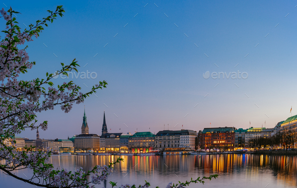 Beautiful panoramic view of calm Alster river with Hamburg town hall - Rathaus behind the buildings - Stock Photo - Images