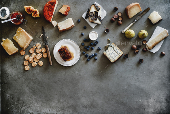 Variety of wine snacks and cheeses over grey background - Stock Photo - Images