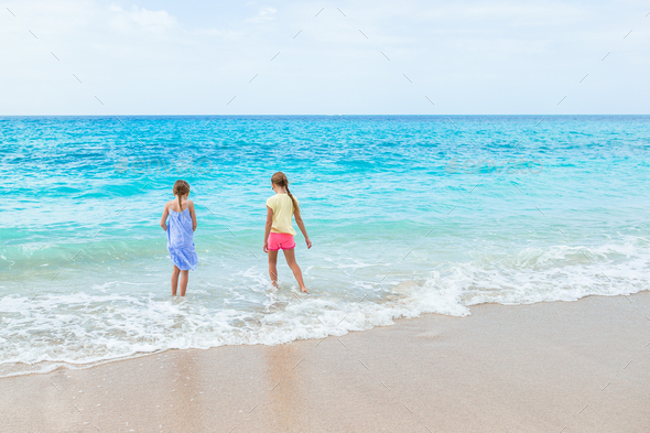Kids have a lot of fun at tropical beach playing together - Stock Photo - Images