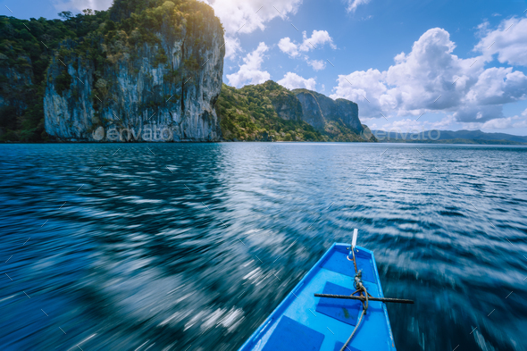 Island hopping Tour boat on speed passing exotic karst limestone islands on travel tour trip