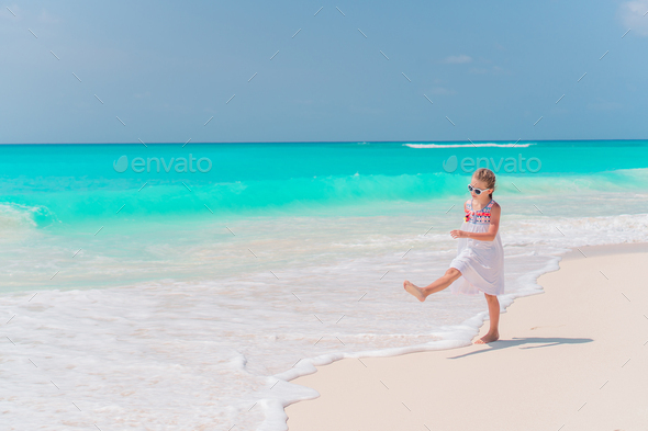 Adorable little girl at beach on her summer vacation Stock Photo by  travnikovstudio