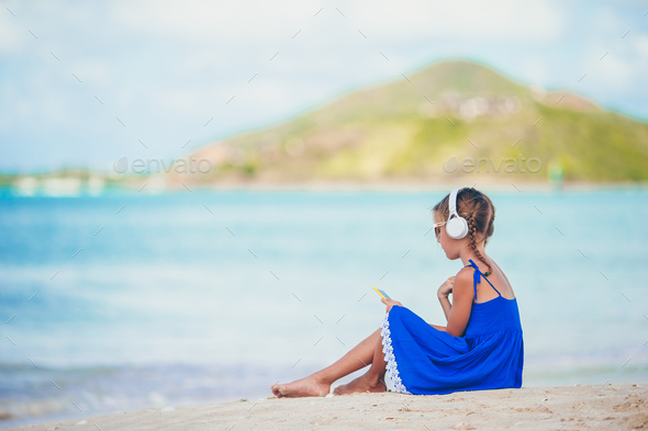 Little adorable girl listening music background sea Stock Photo by ...