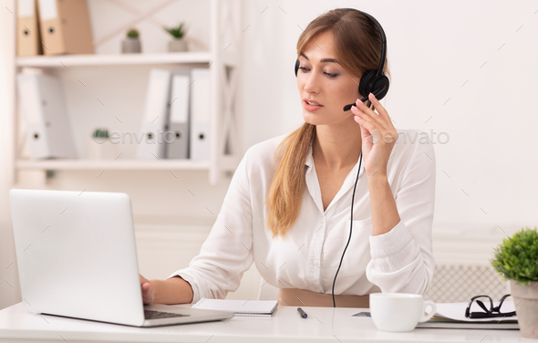 Lady In Headset Having Conversation With Customer In Call Center