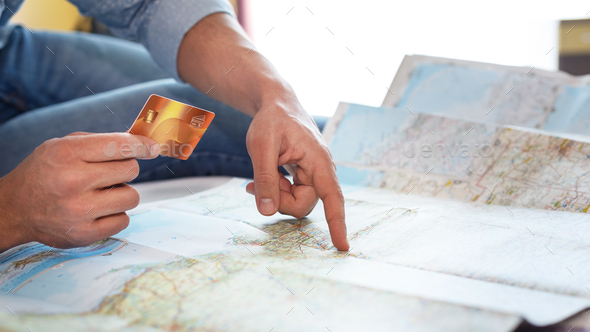 Man holding credit card on world map background