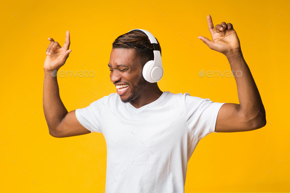 Happy Guy In Headphones Listening To Music Dancing, Studio Shot