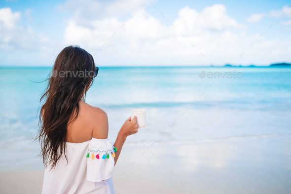 Young woman with cup of hot coffee enjoy holidays