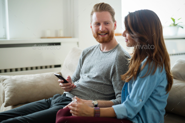 Young couple at home websurfing on internet - Stock Photo - Images