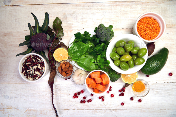 Assortment of foods for healthy liver on white wooden background.