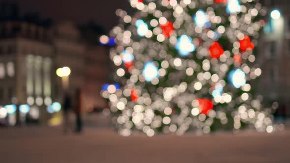 People Walking During New Year in Central Square Near Large Christmas Tree alt