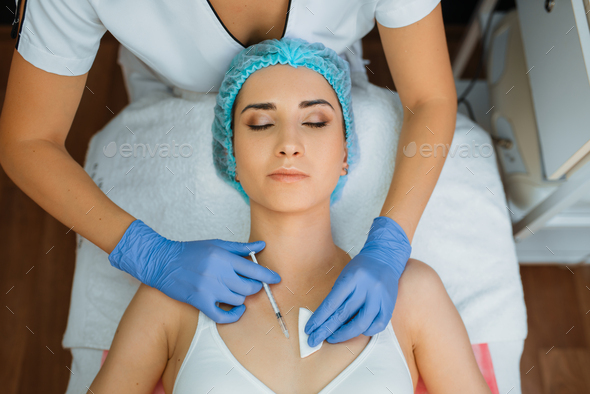 Cosmetician gives botox injection against wrinkles - Stock Photo - Images
