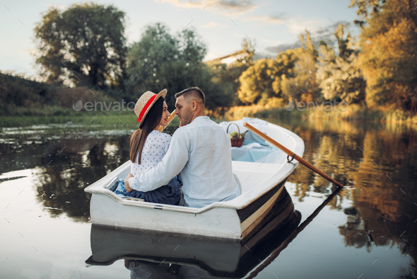 Happy love couple boating on lake, romantic date