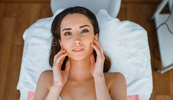 Patient on treatment table in cosmetician's office - Stock Photo - Images