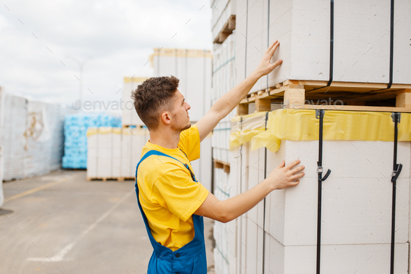 Male builder at the pallets of insulation material