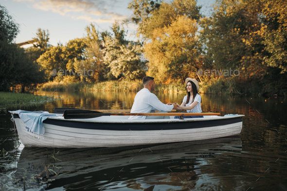 Love couple boating on lake, romantic meeting