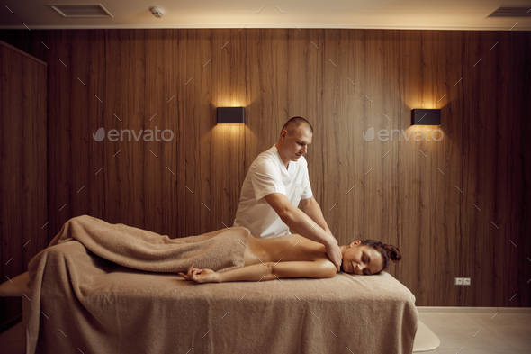 Male masseur pampering neck to young woman - Stock Photo - Images